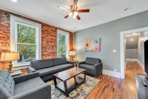 a living room with two couches and a ceiling fan at Central St Louis apartment 1E in Soulard