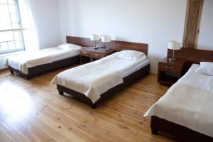 um quarto com duas camas e duas mesas de cabeceira sidx sidx sidx em Hostel Międzynarodowe Centrum Spotkań Młodzieży em Toruń