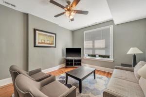 a living room with a couch and a ceiling fan at Ravishing 2-Story Unit in STL 2E in Soulard