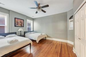 a bedroom with two beds and a ceiling fan at Ravishing 2-Story Unit in STL 2E in Soulard