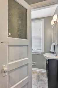 a bathroom with a door with a sink and a counter at Ravishing 2-Story Unit in STL 2E in Soulard