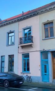 a bike parked in front of a building with blue doors at Roxy's Fishmarket in Leuven