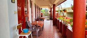 a hallway with tables and chairs on a balcony at Holidayincoorg Brick lane in Madikeri