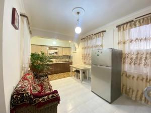 a kitchen with a refrigerator and a table at Lusya B&B in Yeghegnadzor