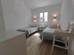 a white room with two beds and a window at Relax bungalow with parking in Playa del Ingles +30 photos