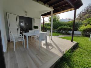 a patio with a white table and chairs on it at Relax bungalow with parking in Playa del Ingles