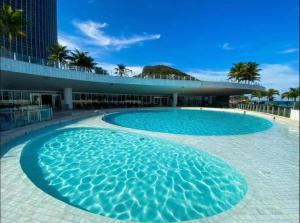 a large swimming pool in front of a building at Hotel Nacional Rio de Janeiro in Rio de Janeiro