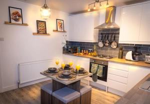 a kitchen with a table with candles on it at A Cosy, Elegant 3 Bed Suite in Killingbeck