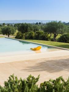 a yellow object sitting in the middle of a swimming pool at Agua Green Resort in San Lorenzo