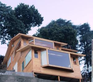 a house being built on a foundation with trees in the background at THE GRAND RESORT DHANOLTI in Dhanaulti