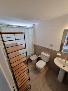uma casa de banho com um WC e um lavatório em Alójate en este espacioso departamento mensual em Córdoba