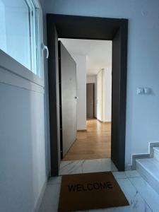a hallway with a welcome mat in front of a door at Iris Luxury Apartment in Ioannina