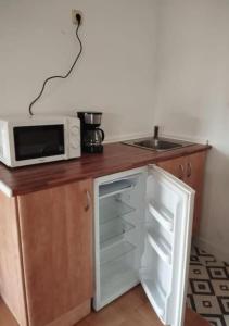 a small kitchen with a microwave and a refrigerator at Isla in Oiartzun