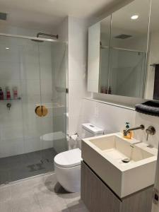 a bathroom with a toilet and a sink and a shower at The Forest in the heart of CBD in Adelaide