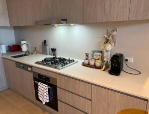 a kitchen with a stove and a counter top at The Forest in the heart of CBD in Adelaide