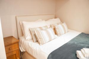 a bedroom with a bed with white pillows at Recently updated lodge near Chester city centre - For up to 6 in Chester
