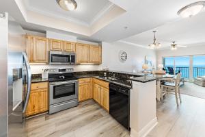 a kitchen with wooden cabinets and a counter top at Crystal Tower Unit 1508 in Gulf Shores