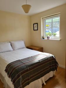 a bedroom with a bed and a window at Quay village 16 in Westport
