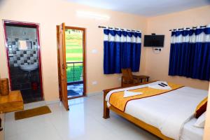 a bedroom with a bed and a bathroom at J J HOMES in Ooty