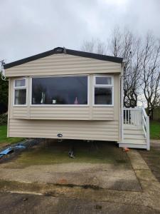 a house with a large window on the side of it at Lovely 8 Berth Caravan With Decking And Wifi In Yorkshire, Ref 71011ic in Tunstall