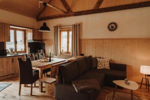 a living room with a couch and a table at Oberwald Chalets 1 in Schotten