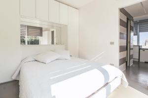 a white bedroom with a bed and white cabinets at La Sosta in San Siro