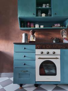 a kitchen with a blue cabinet and a stove at Nummenpakan Pysäkki in Turku