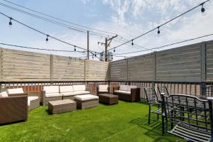 a patio with couches and chairs on the grass at Central Chicago Suite Access to Patio Suite 1 in Chicago
