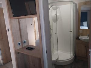 a bathroom with a shower and a sink at Camber Sands Holiday Park in Camber +41 photos