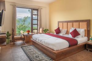 a bedroom with a large bed with a large window at Kasauli Jungle tree in Kasauli