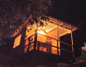 a house with lights on the side of it at night at Macheta Climbing House in Machetá