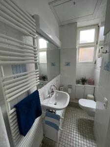 uma casa de banho branca com um lavatório e um WC em Ruhig & Mitten in der Altstadt, nahe Uni&Schloss em Heidelberg