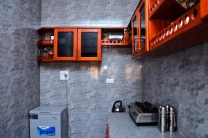a kitchen with a counter with a microwave and a stove at Habermotel Enterprises Ltd in Entebbe