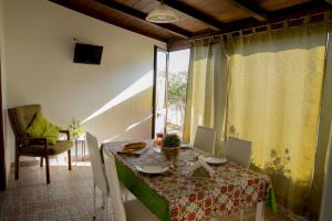 a dining room with a table and a window at Villa I Due Pini in San Vito lo Capo +55 photos
