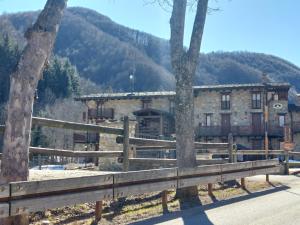 a building with a fence and trees in front of it at House Fiocco di Neve by Holiday World in Limone Piemonte