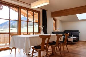 a dining room with a table and chairs and a large window at Apartment Vordermitterast in Kirchberg in Tirol