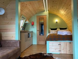a bedroom with a bed and a kitchen in a room at Beautiful Seaview Lodge overlooking Loch Linnhe in Fort William
