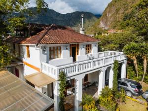 an aerial view of a white house with a balcony at 593 Hotel Boutique Baños in Baños