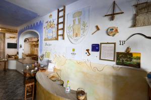 a room with a wall with drawings on it at Antico Borgo Marchese in Morciano di Leuca