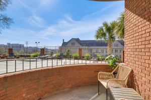 a brick wall with two benches in front of a building at Columbia Vacation Rental - Walk to UofSC Campus! in Columbia