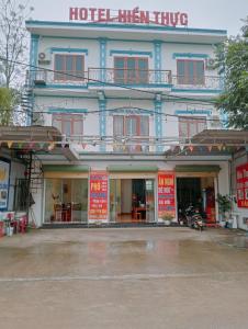 a hotel with red signs in front of a building at Hien Thuc Hotel in Ninh Binh