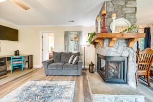 a living room with a couch and a fireplace at Wilmington Getaway Near Carolina Beach Boardwalk! in Wilmington