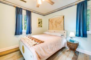 a bedroom with a large bed with blue curtains at Wilmington Getaway Near Carolina Beach Boardwalk! in Wilmington