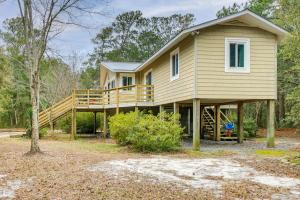 a house with a large deck with a porch at Wilmington Getaway Near Carolina Beach Boardwalk! in Wilmington