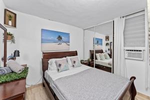 a bedroom with a bed and a view of a beach at Lupa Guesthouse affordable family home in Rincon