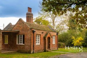 an old brick house with a chimney on top at Luxurious Vineyard Hideaway At Stanlake Park in Wokingham