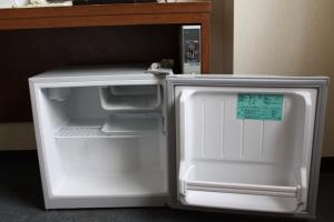 an empty refrigerator with its door open in a room at Hotel Green City in Sendai