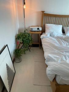 a bedroom with a bed and a table with a clock at Escondite.no1 in Ulsan