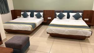 Postelja oz. postelje v sobi nastanitve Hotel Omkareshwar Inn