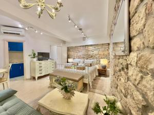 a large living room with a stone wall at CUORE DI ROVIGNO in Rovinj